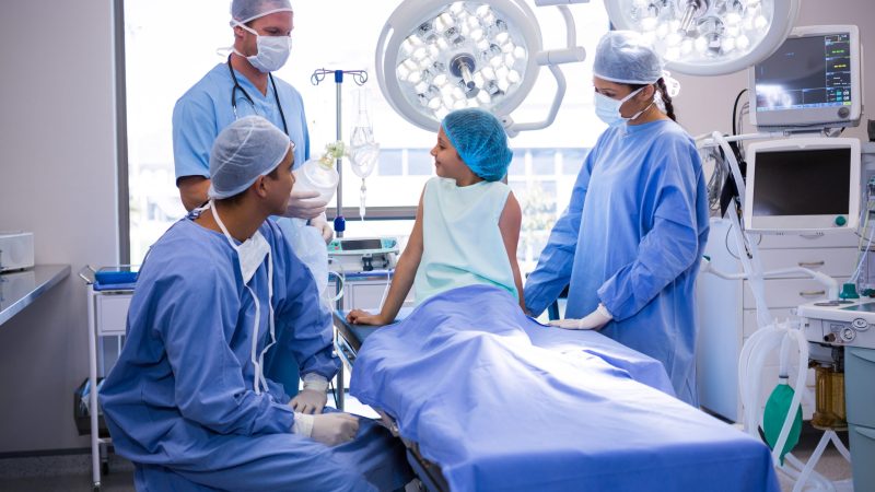 Doctor interacting with patient in operation room at hospital